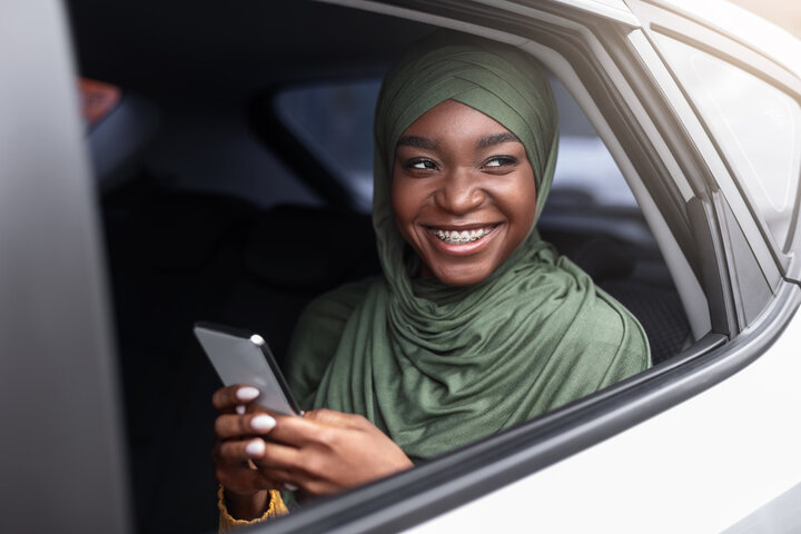A rider sitting comfortably in the back of a car